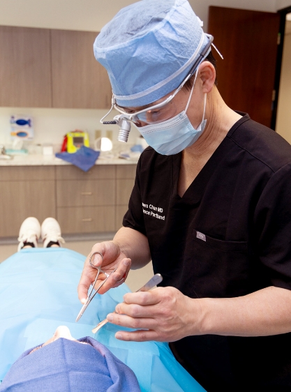 Dr. Chan, performing a facial cosmetic procedure.